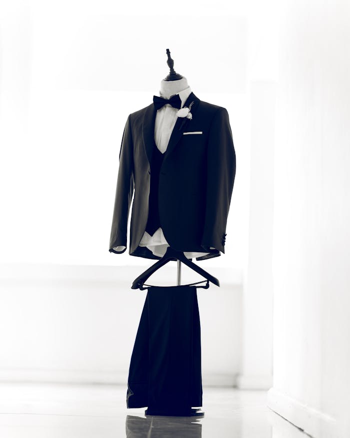 Classic tuxedo on a mannequin with a bow tie, perfect for formal events.